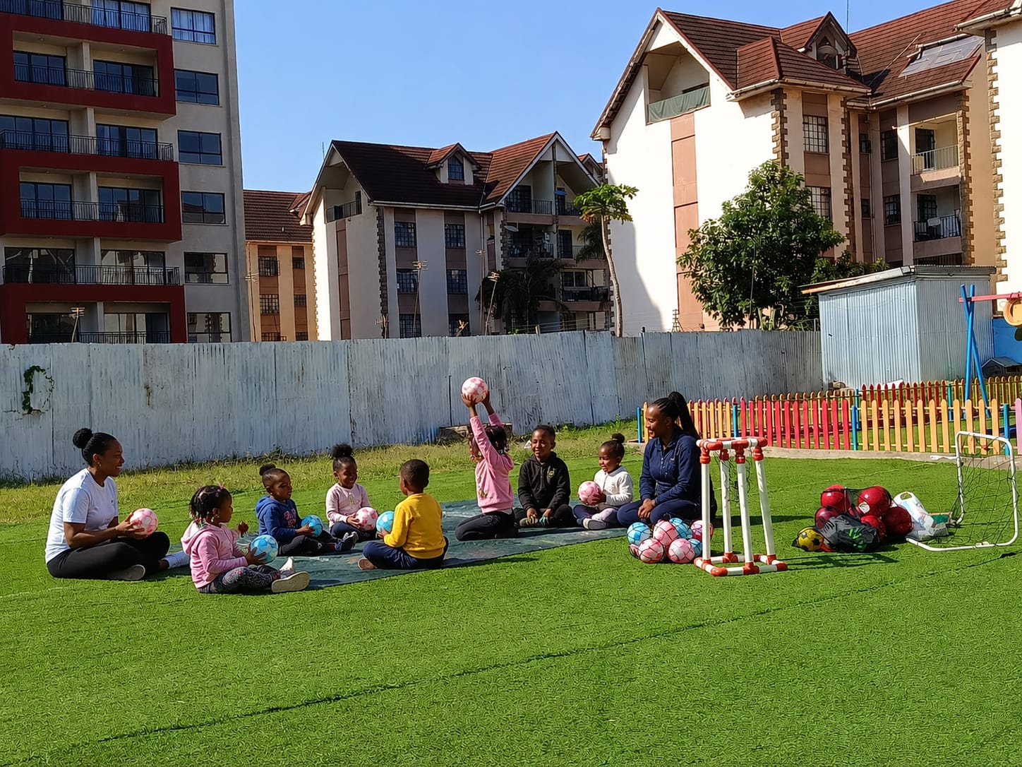 Children in a sports circle with their coach